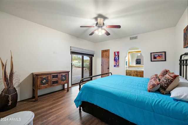 bedroom with connected bathroom, ceiling fan, and dark wood-type flooring