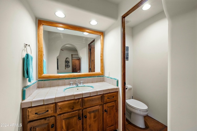 bathroom with vanity and toilet