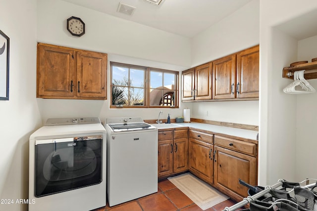 laundry area featuring cabinets, tile patterned flooring, separate washer and dryer, and sink