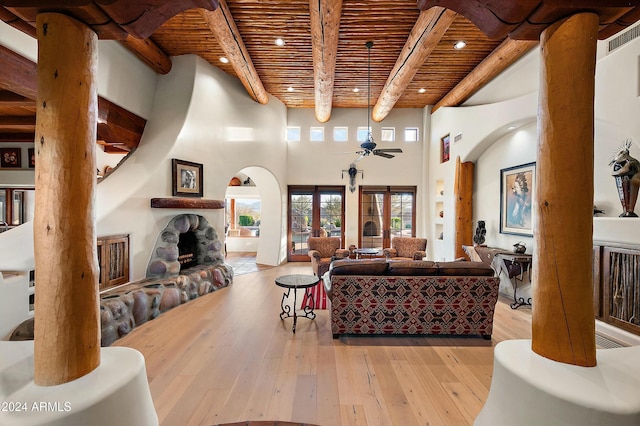 living room with wooden ceiling, french doors, ceiling fan, beamed ceiling, and light hardwood / wood-style floors