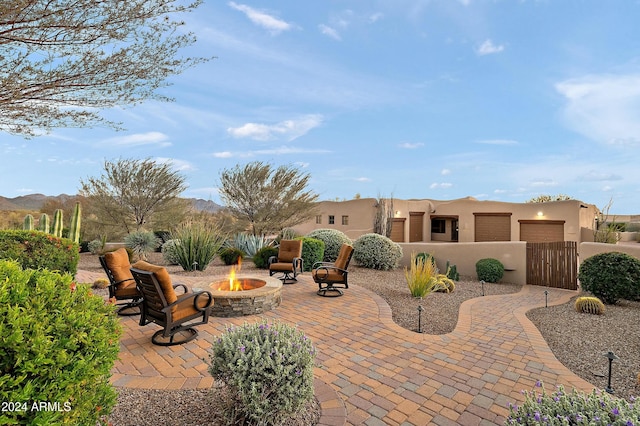 view of patio featuring a fire pit and a mountain view