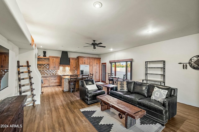 living room with ceiling fan and dark hardwood / wood-style flooring