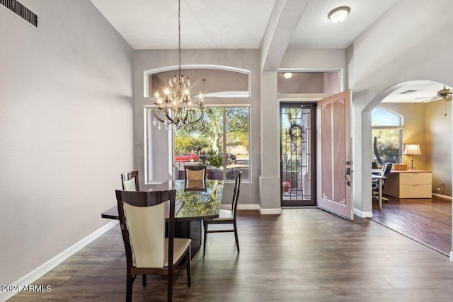 dining space featuring ceiling fan with notable chandelier, dark hardwood / wood-style flooring, and a wealth of natural light