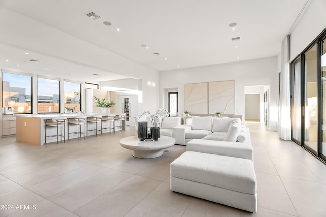 tiled living room featuring a healthy amount of sunlight