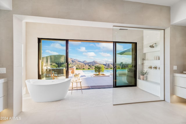 interior space with a mountain view, a healthy amount of sunlight, and tile patterned flooring