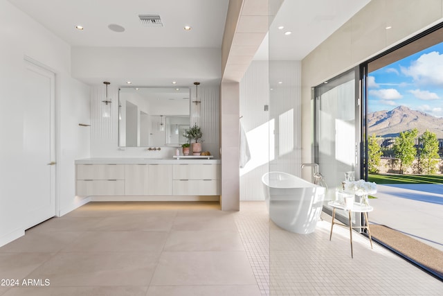 bathroom with vanity, a mountain view, tile patterned floors, and independent shower and bath