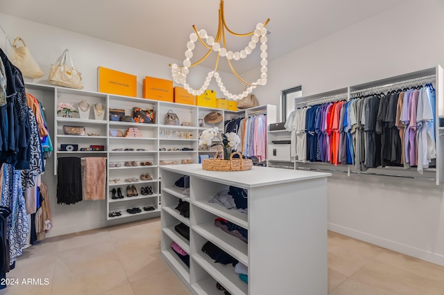 walk in closet with a chandelier