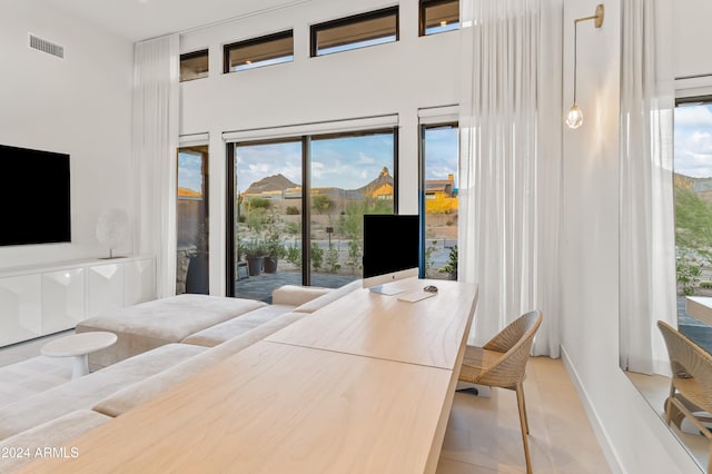 bedroom featuring multiple windows, access to outside, and light tile patterned floors