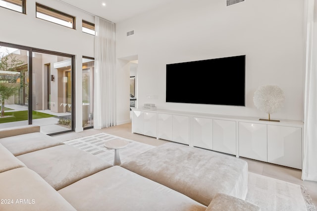 living room featuring a towering ceiling