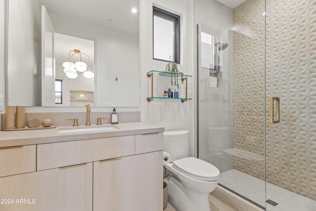 bathroom featuring vanity, toilet, and an enclosed shower