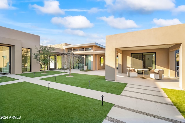 rear view of property with a patio area and a lawn