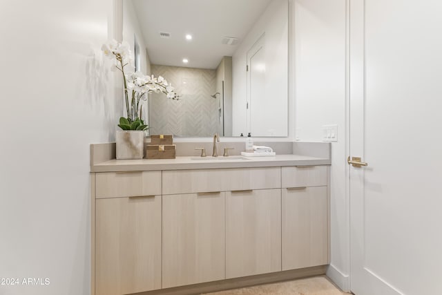 bathroom with vanity and a shower