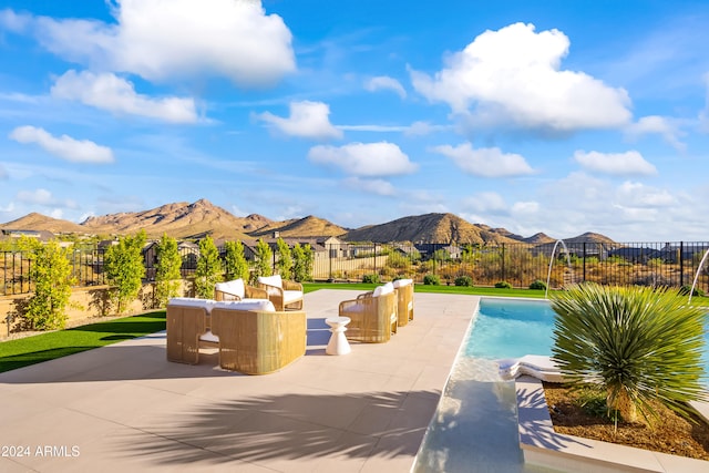 view of swimming pool with a patio area and a mountain view