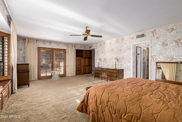 carpeted bedroom featuring ceiling fan, access to exterior, and multiple windows