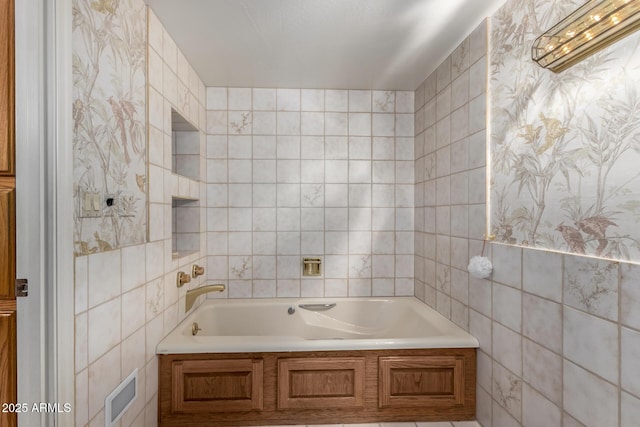 bathroom with tile walls and a bathtub