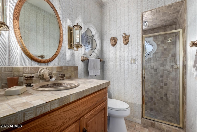 bathroom featuring an enclosed shower, vanity, and toilet