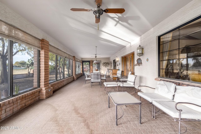 sunroom featuring ceiling fan