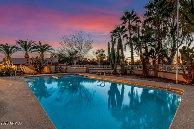 view of pool at dusk