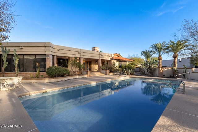 view of swimming pool with a patio and an in ground hot tub