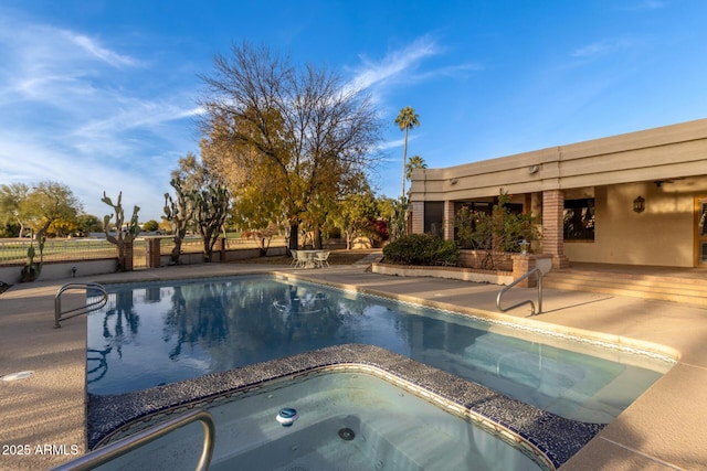 view of pool with an in ground hot tub and a patio