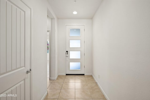 doorway to outside with light tile flooring