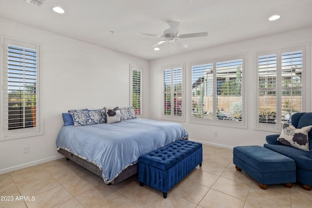 tiled bedroom with multiple windows and ceiling fan