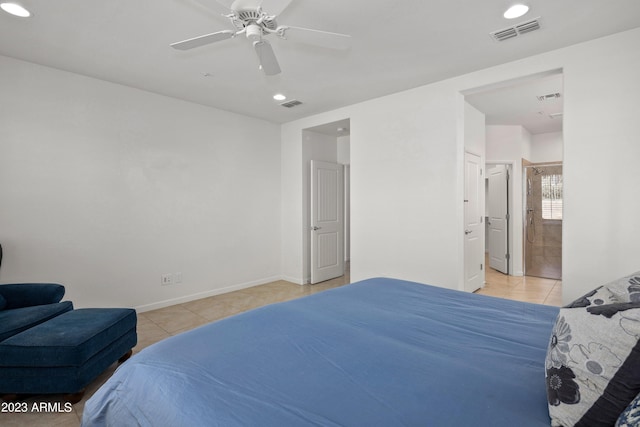 bedroom featuring light tile floors, ceiling fan, and ensuite bathroom