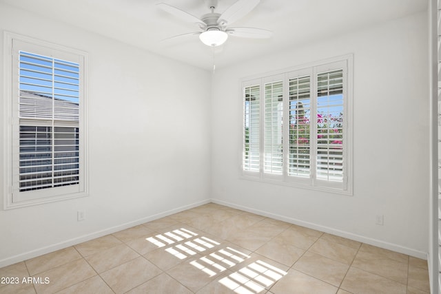 empty room featuring ceiling fan and light tile floors