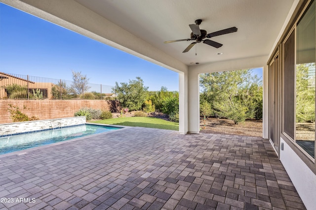 view of patio / terrace with ceiling fan, pool water feature, and a fenced in pool