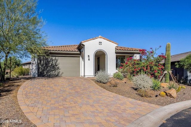 mediterranean / spanish home featuring a garage