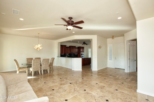 living room with sink and ceiling fan with notable chandelier