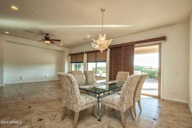 dining area with ceiling fan with notable chandelier