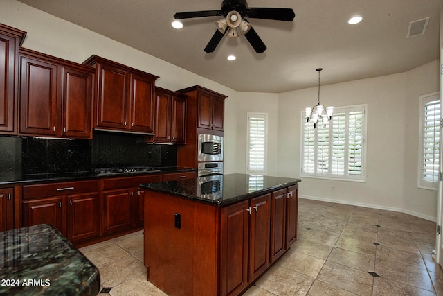 kitchen with a kitchen island, a healthy amount of sunlight, backsplash, and appliances with stainless steel finishes