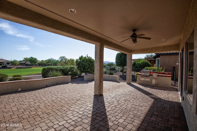 view of patio with ceiling fan and area for grilling