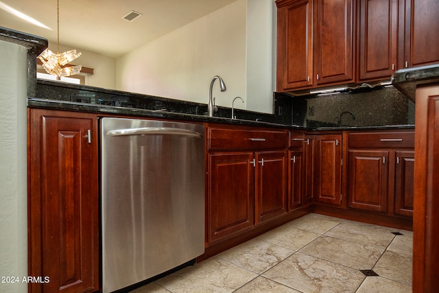 kitchen with dark stone counters, dishwasher, hanging light fixtures, a notable chandelier, and backsplash