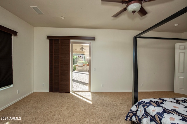 unfurnished bedroom featuring light colored carpet and ceiling fan