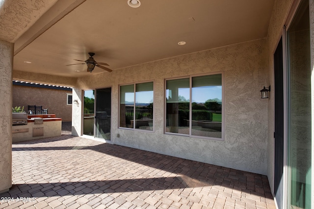 view of patio featuring area for grilling and ceiling fan