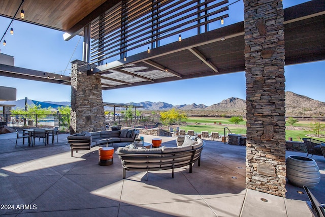 view of patio with a mountain view and an outdoor living space