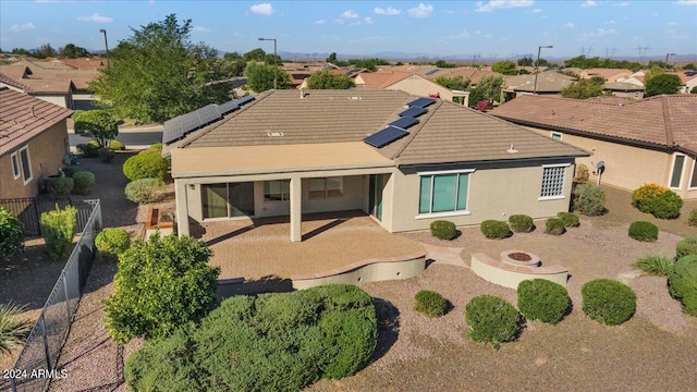 back of property featuring a patio area and a fire pit