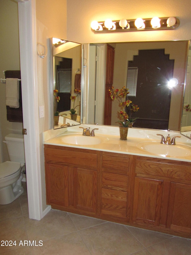 bathroom with tile patterned floors, vanity, and toilet