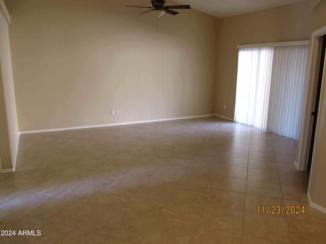 tiled spare room with ceiling fan