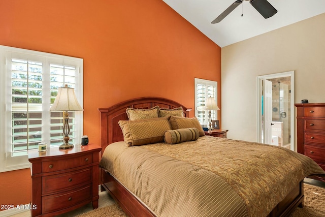 bedroom with ceiling fan, ensuite bathroom, and vaulted ceiling