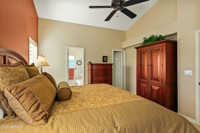 bedroom with vaulted ceiling, ceiling fan, and ensuite bath