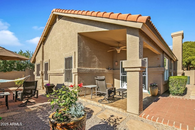 back of house featuring a patio area and ceiling fan