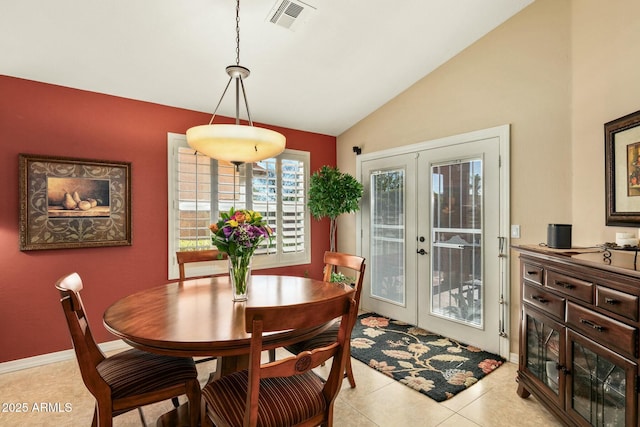 tiled dining room with french doors and vaulted ceiling