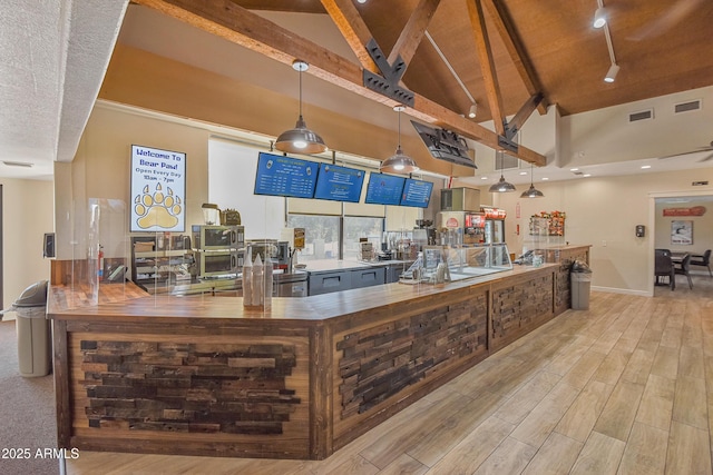 2665 N Valley View Rd Unit 10130, Flagstaff, AZ 86004 - bar with high vaulted ceiling, beam ceiling, rail lighting, light wood-type flooring, and hanging light fixtures