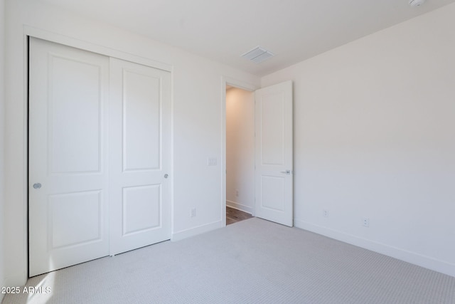 11857 N Luckenbach St, Surprise, AZ 85388 - unfurnished bedroom featuring a closet, carpet, and baseboards