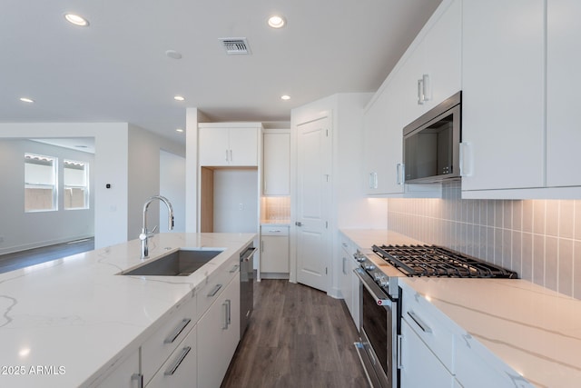 11857 N Luckenbach St, Surprise, AZ 85388 - kitchen with a sink, stainless steel appliances, wood finished floors, white cabinetry, and backsplash