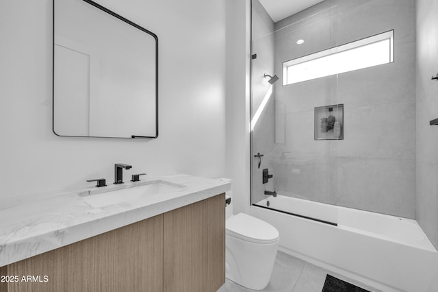 full bathroom featuring tiled shower / bath combo, vanity, tile patterned floors, and toilet