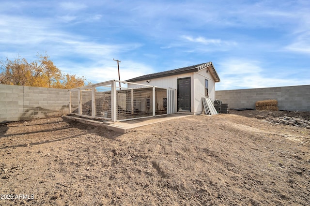 back of property with an outdoor structure